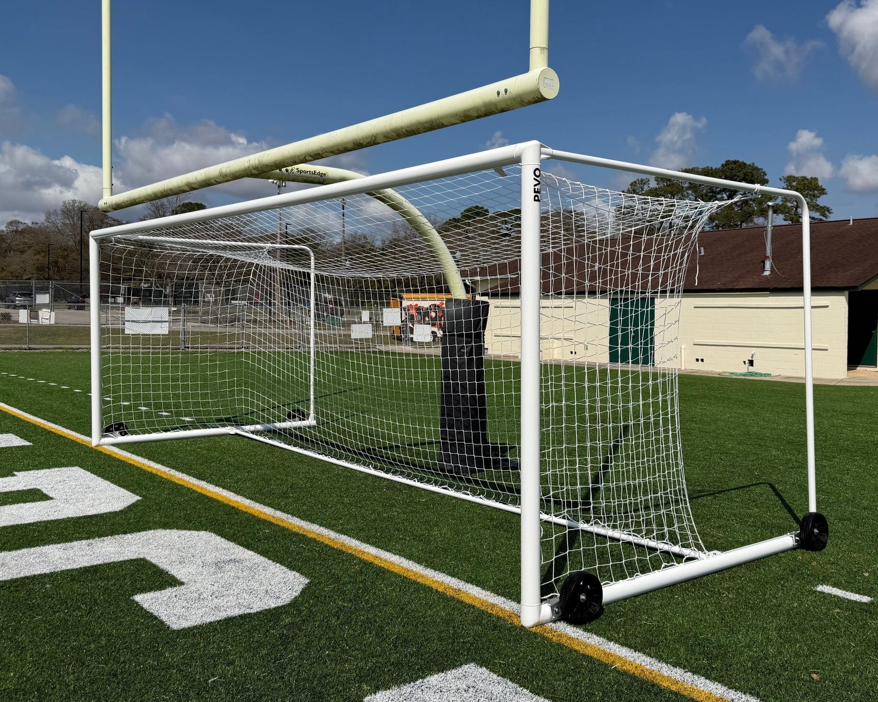 Stadium series soccer goal on field showing multi-use football field installation