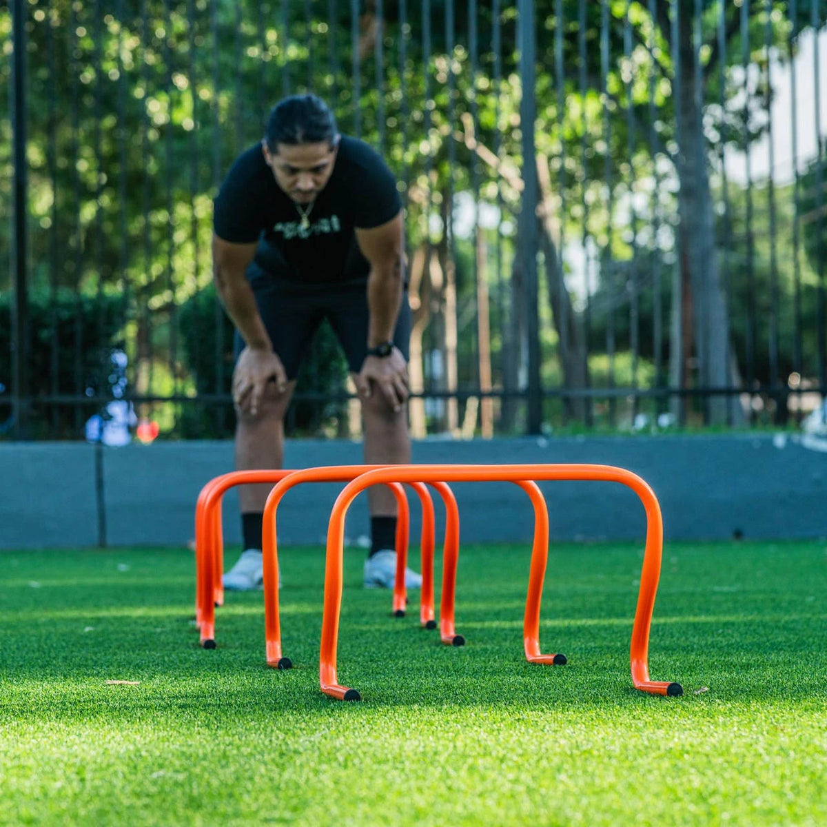 Bright orange 12-inch PVC hurdle with bounce-back construction for soccer training