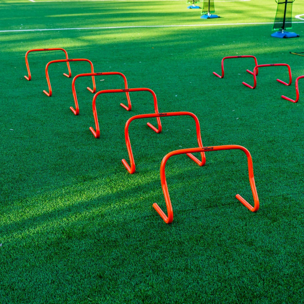 Bright orange 12-inch PVC hurdle with bounce-back construction for soccer training