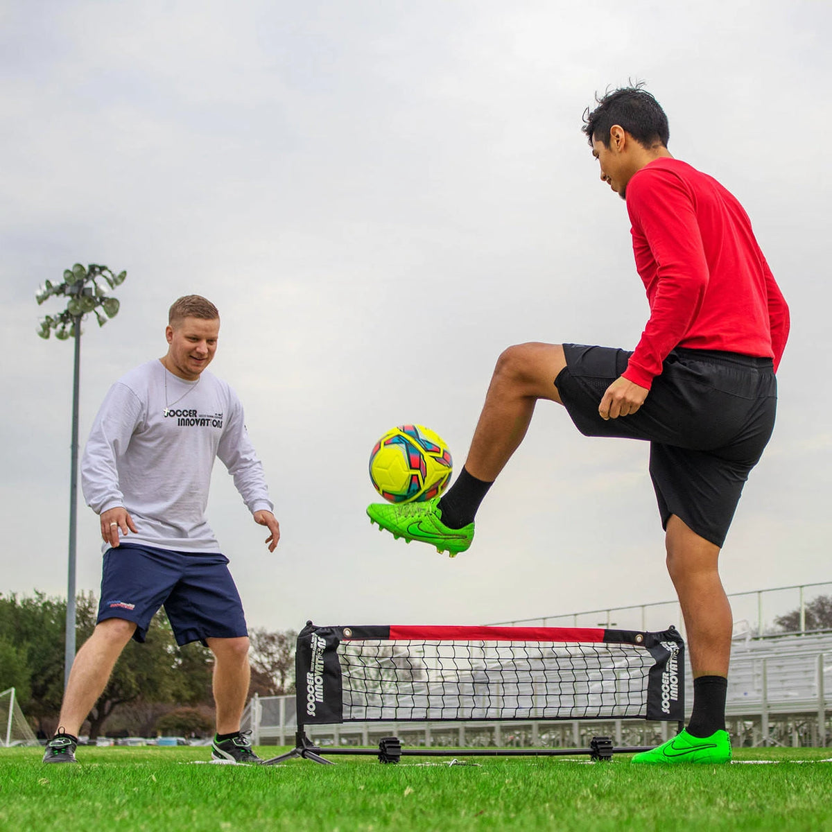 Mini soccer tennis net 4-foot compact setup with boundary markers on field for small-sided training