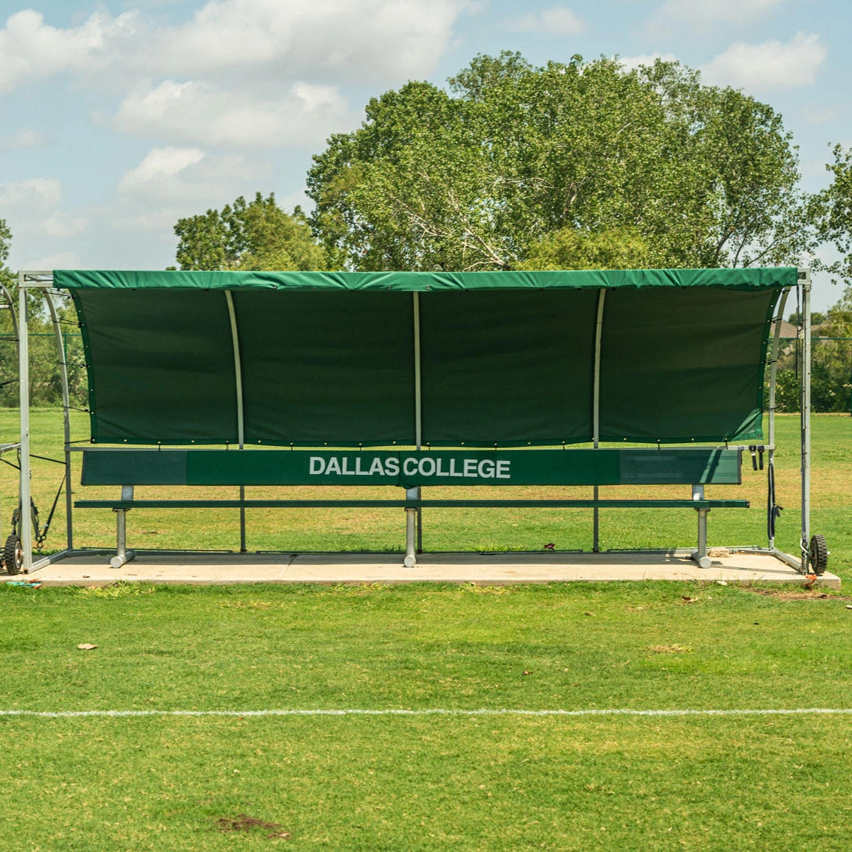 Team shelter structure with summer cover showing professional sideline infrastructure setup