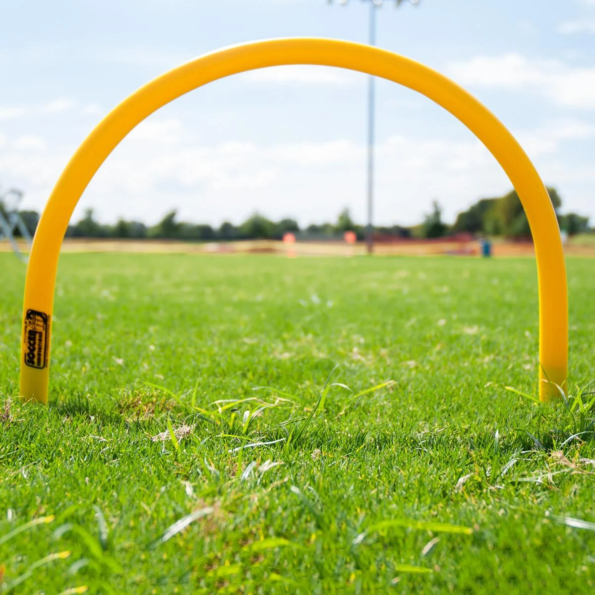Training passing arc showing curved top design and retractable spike base for ground installation