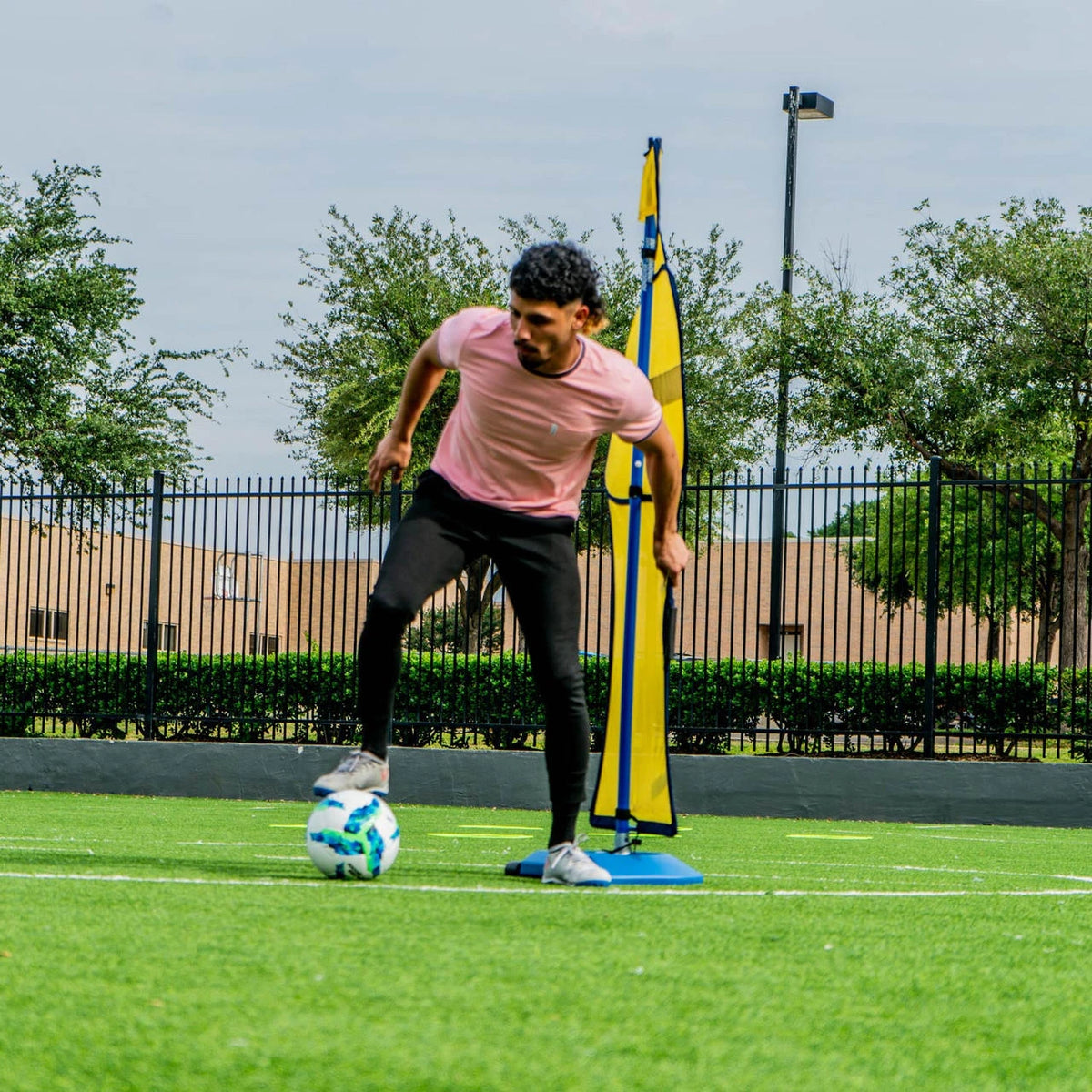 Soccer wall training mannequin with wind-resistant mesh body and telescoping pole
