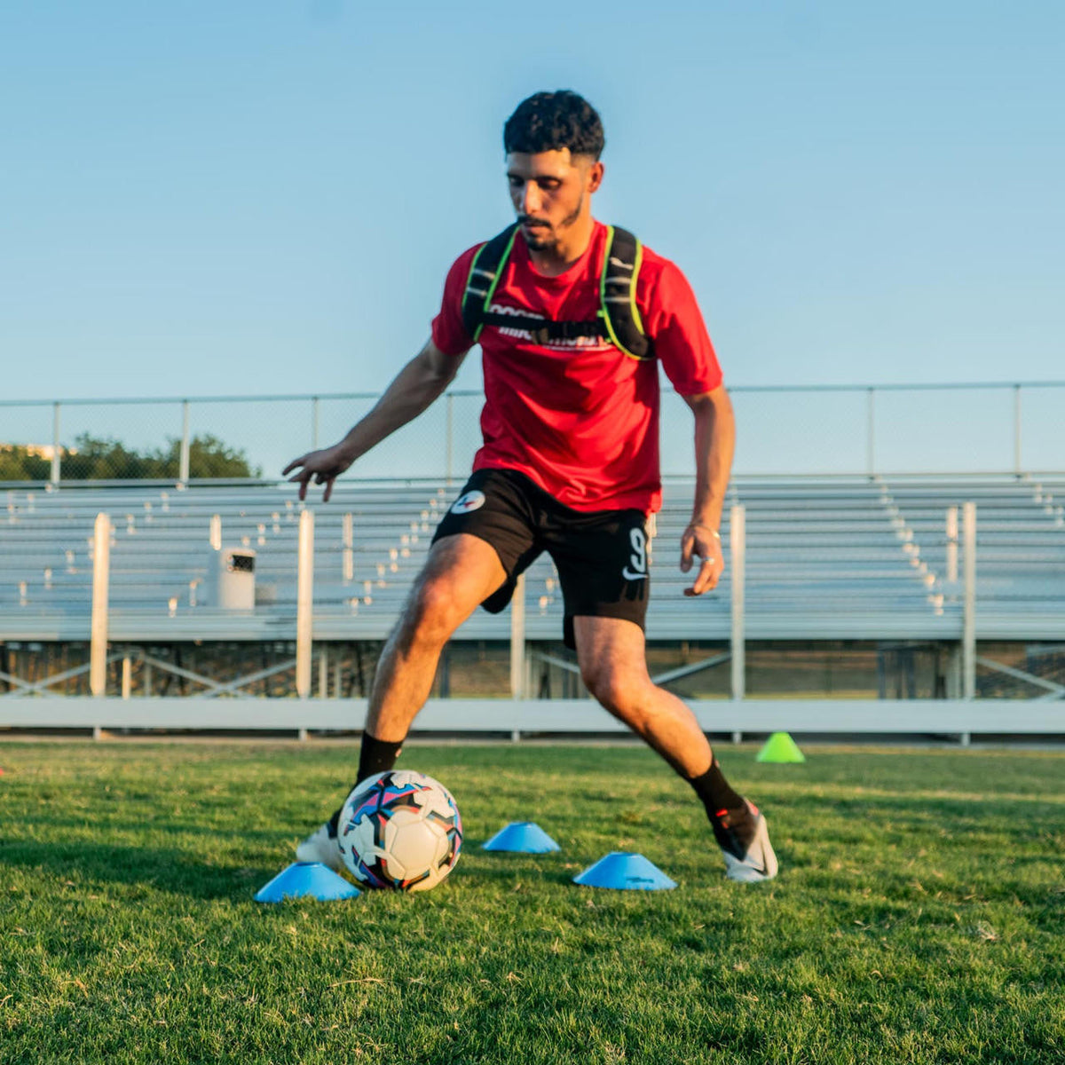 Athlete wearing slim weight vest during dynamic training movement and sprint drill